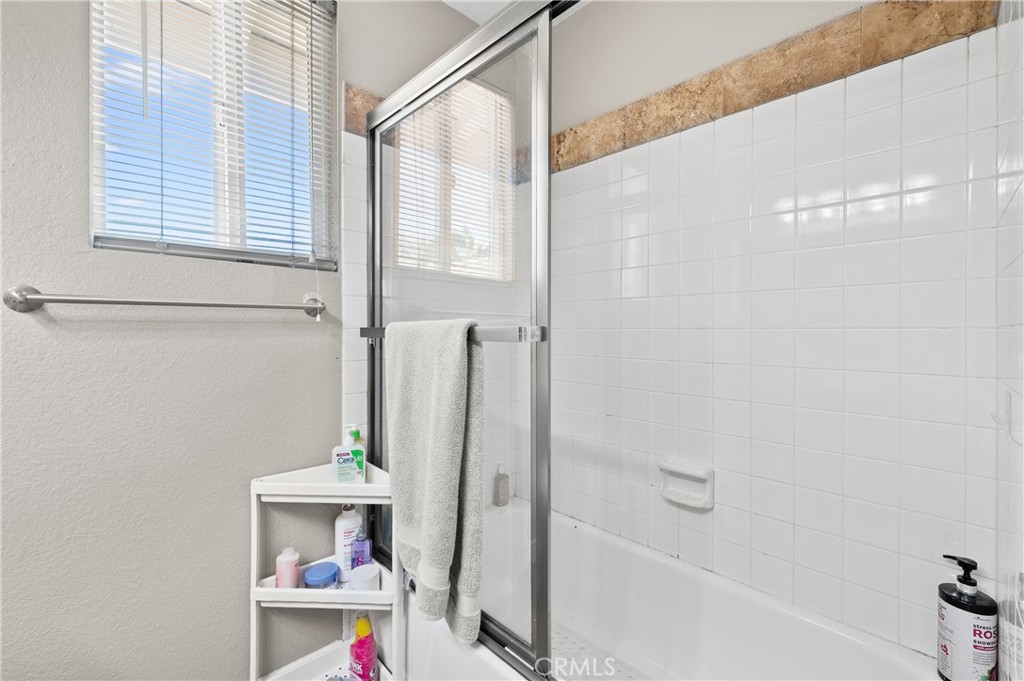 6933 Stanislaus Place Rancho Cucamonga, CA 91701 - Photo 29 of 54 a bathroom with a bathtub and a shower