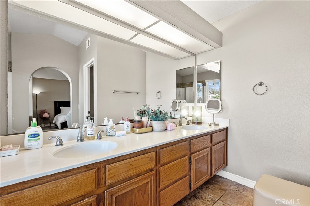 6933 Stanislaus Place Rancho Cucamonga, CA 91701 - Photo 39 of 54 a bathroom with a sink and mirror with toilet