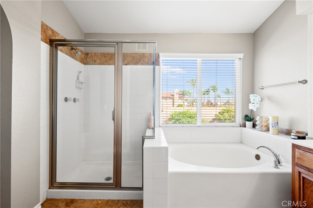 6933 Stanislaus Place Rancho Cucamonga, CA 91701 - Photo 41 of 54 a bathroom with a bathtub and a shower