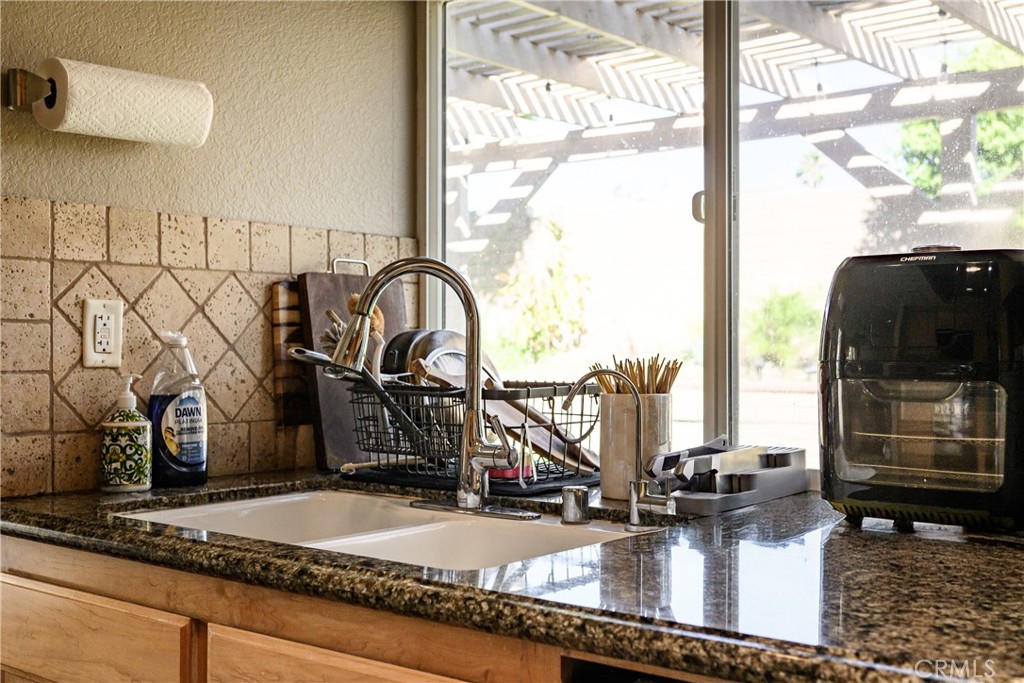 6933 Stanislaus Place Rancho Cucamonga, CA 91701 - Photo 47 of 54 a bathroom with a granite countertop sink and a mirror