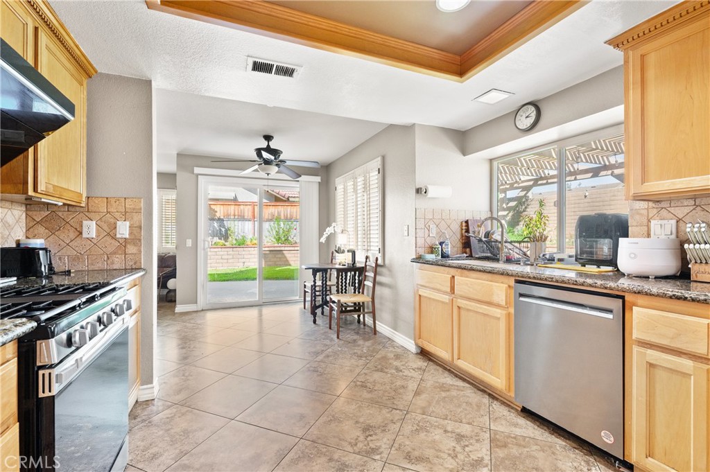 6933 Stanislaus Place Rancho Cucamonga, CA 91701 - Photo 10 of 54 a kitchen with appliances cabinets and a table