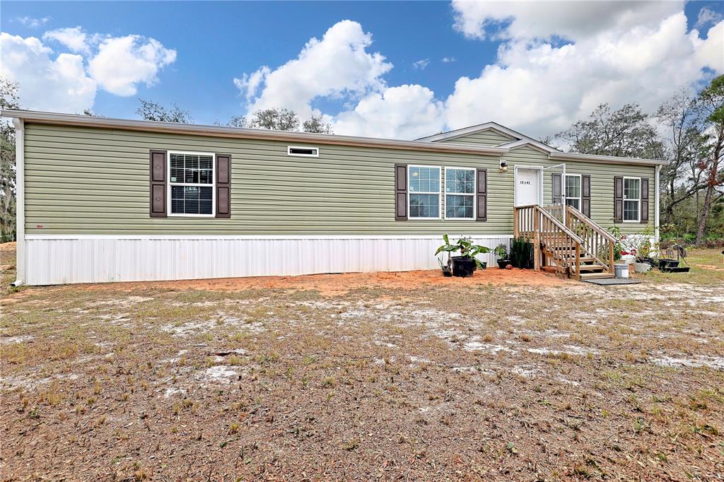 1541 McClellan Road Frostproof, FL 33843 - Photo 1 of 1 a view of a house with backyard and sitting area