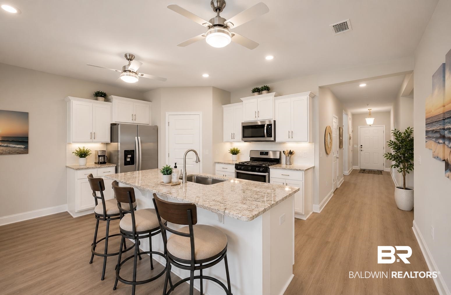 31468 Memphis Loop Daphne, AL 36527 - Photo 6 of 24 Kitchen featuring white cabinetry, stainless steel appliances, granite countertops, an island with a stainless steel farmhouse sink, and wood-finish flooring