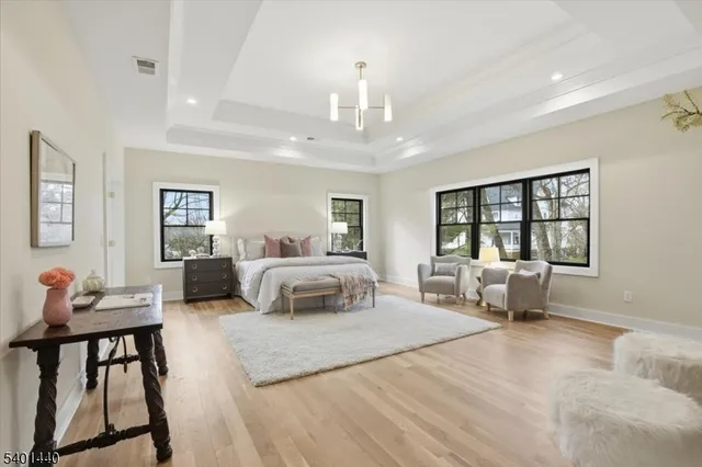 a bedroom with furniture and a chandelier