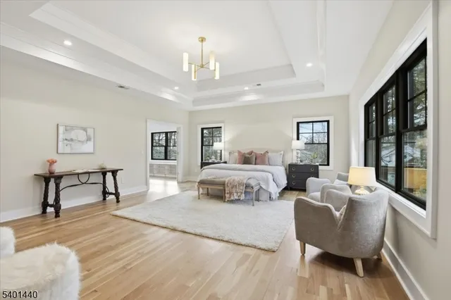 a bed room with a bed mirror and a desk