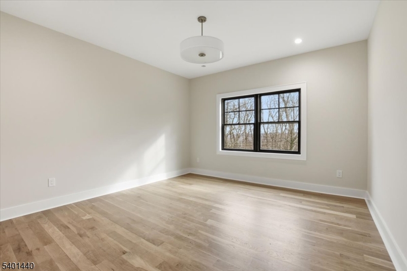 336 Fairmount Avenue Chatham, NJ 07928 - Photo 26 of 45 wooden floor in an empty room with a window