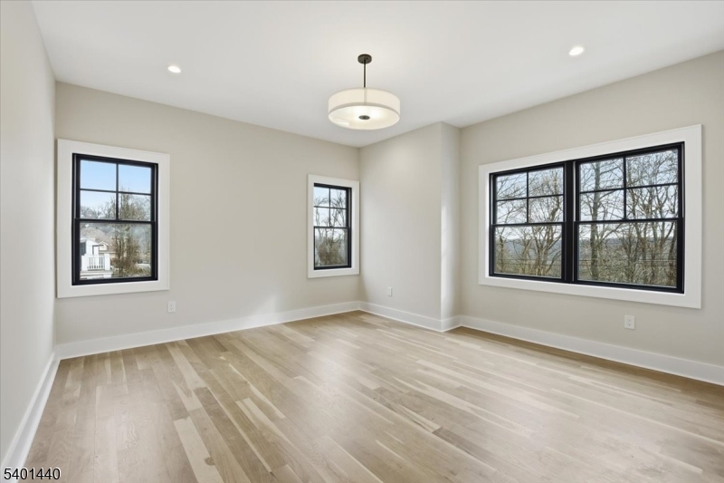 336 Fairmount Avenue Chatham, NJ 07928 - Photo 28 of 45 a view of an empty room with a window and wooden floor