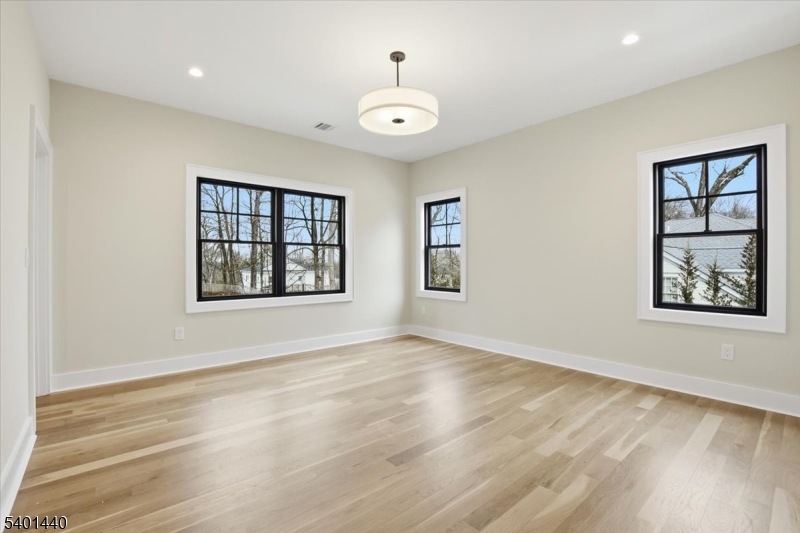336 Fairmount Avenue Chatham, NJ 07928 - Photo 33 of 45 a view of an empty room with window and wooden floor