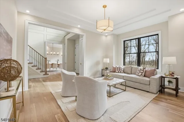 a living room with furniture and a chandelier