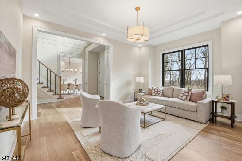 336 Fairmount Avenue Chatham, NJ 07928 - Photo 6 of 45 a living room with furniture and a chandelier