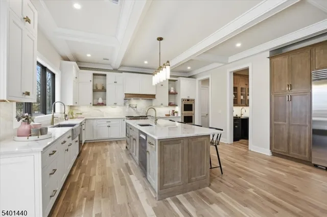 a kitchen with a sink a counter top space stainless steel appliances cabinets and a window