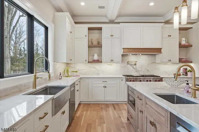 a kitchen with a sink stove top oven and cabinets