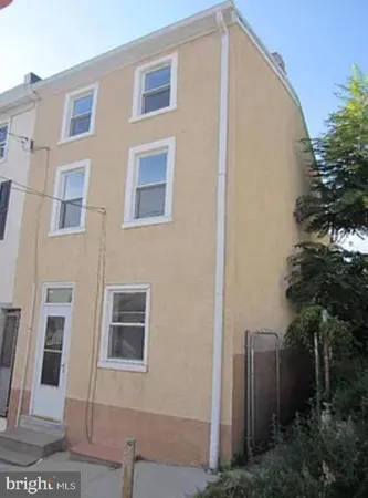 a front view of a house with plants