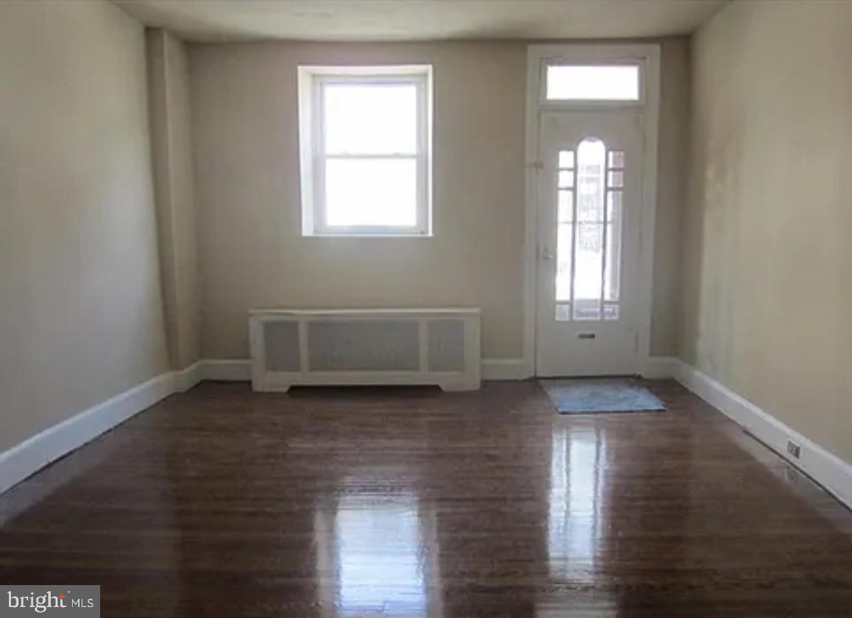 192 Conarroe Street Philadelphia, PA 19127 - Photo 5 of 7 a view of a livingroom with wooden floor and window