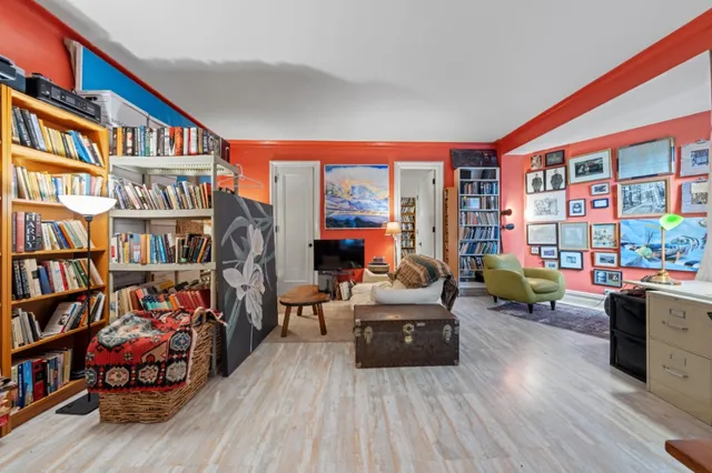 a living room with lots of furniture and a book shelf
