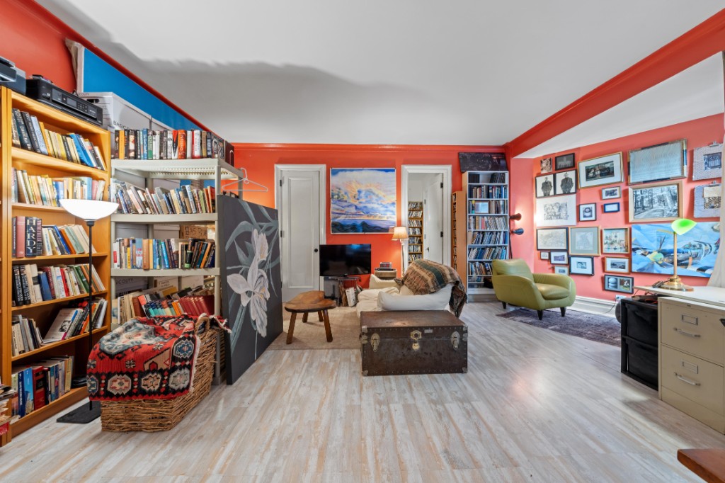 790 Riverside Drive, Unit 3H Manhattan, NY 10032 - Photo 2 of 7 a living room with lots of furniture and a book shelf