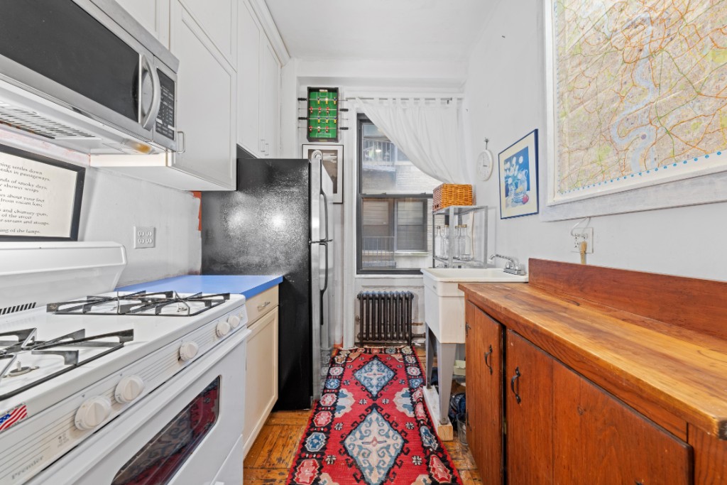 790 Riverside Drive, Unit 3H Manhattan, NY 10032 - Photo 5 of 7 a kitchen with stainless steel appliances granite countertop a stove and a sink