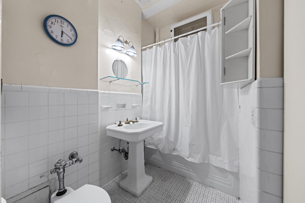 790 Riverside Drive, Unit 3H Manhattan, NY 10032 - Photo 6 of 7 a bathroom with a sink toilet and shower