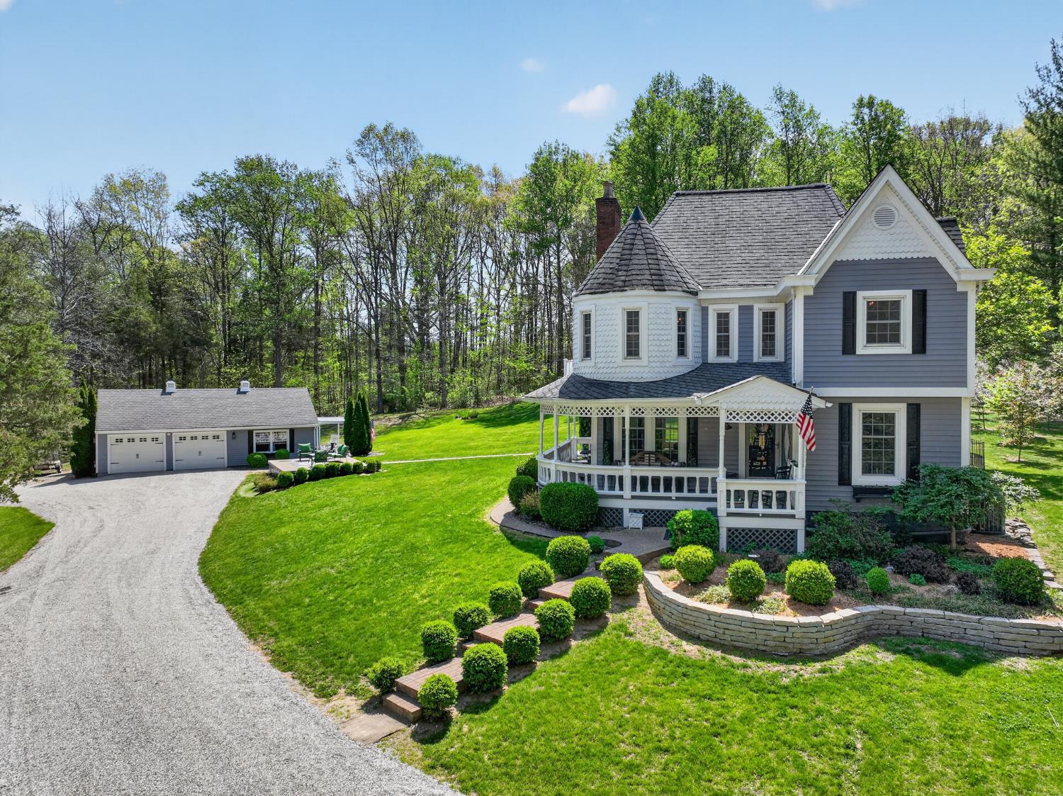 A spacious outbuilding beyond the home provides an oversized 2 car garage plus a separate office and side porch.