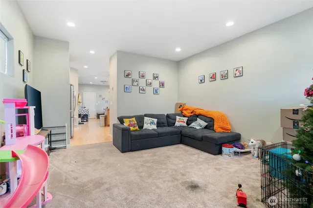 a living room with furniture and a potted plant