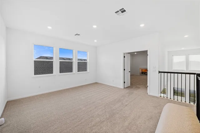 a view of an empty room with kitchen