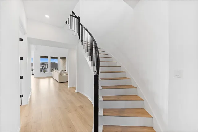 a view of entryway and hall with wooden floor