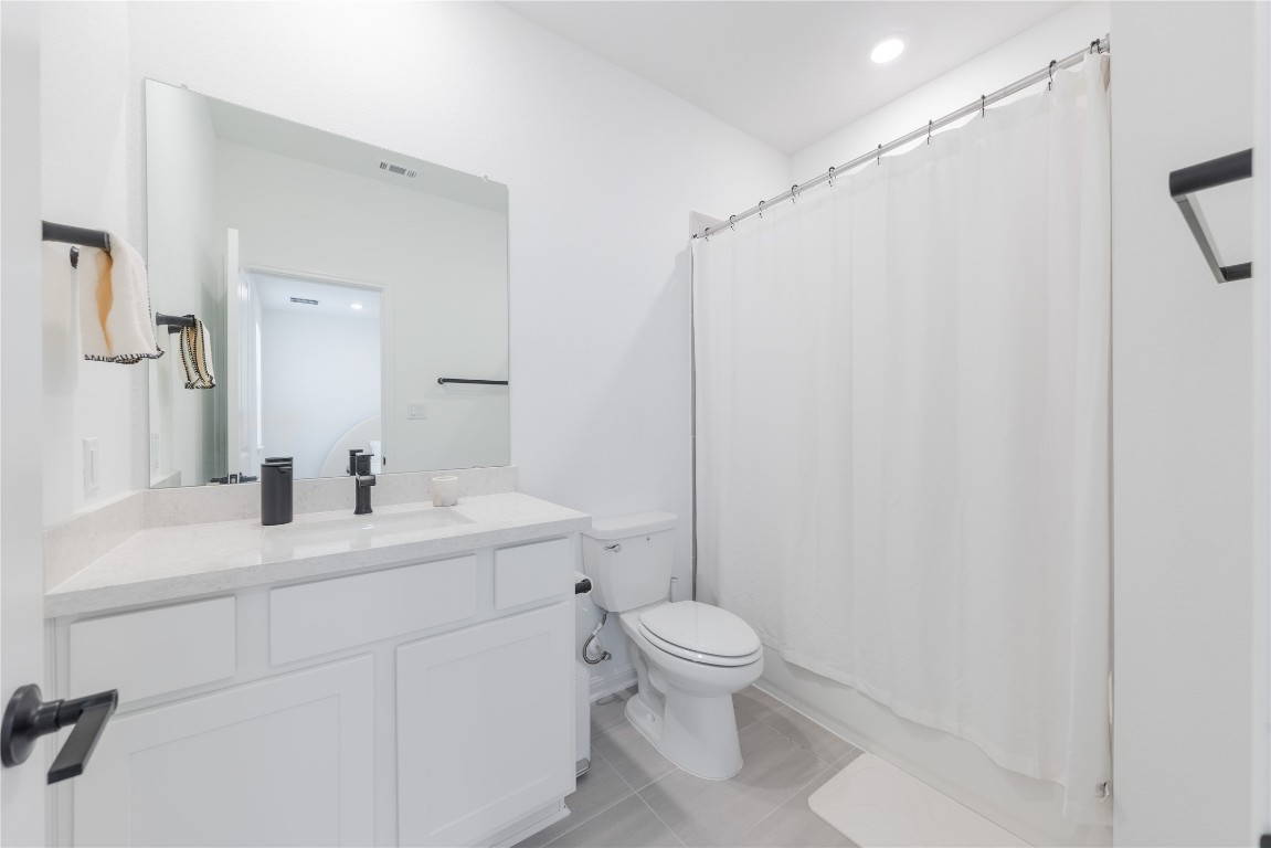 1953 Varese Path Leander, TX 78641 - Photo 23 of 36 a bathroom with a sink a toilet and shower