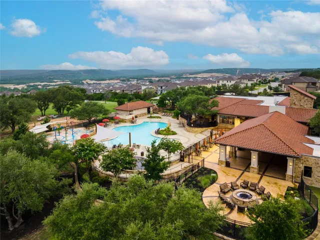 an aerial view of a houses with a city view