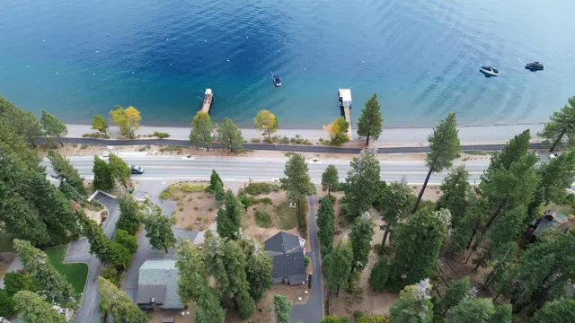 a white house that has a small yard next to a road