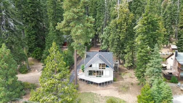 an aerial view of a house with yard
