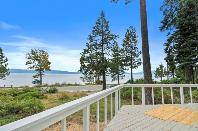 a balcony with wooden floor and fence