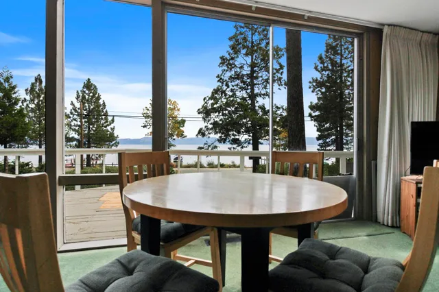 a dining room with furniture and a large window
