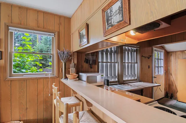 a kitchen with stainless steel appliances a sink stove and cabinets