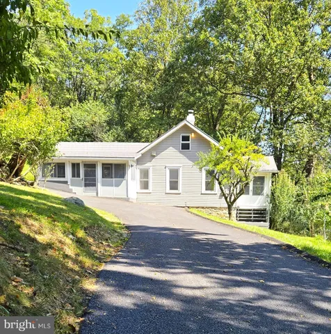a front view of a house with a garden and yard