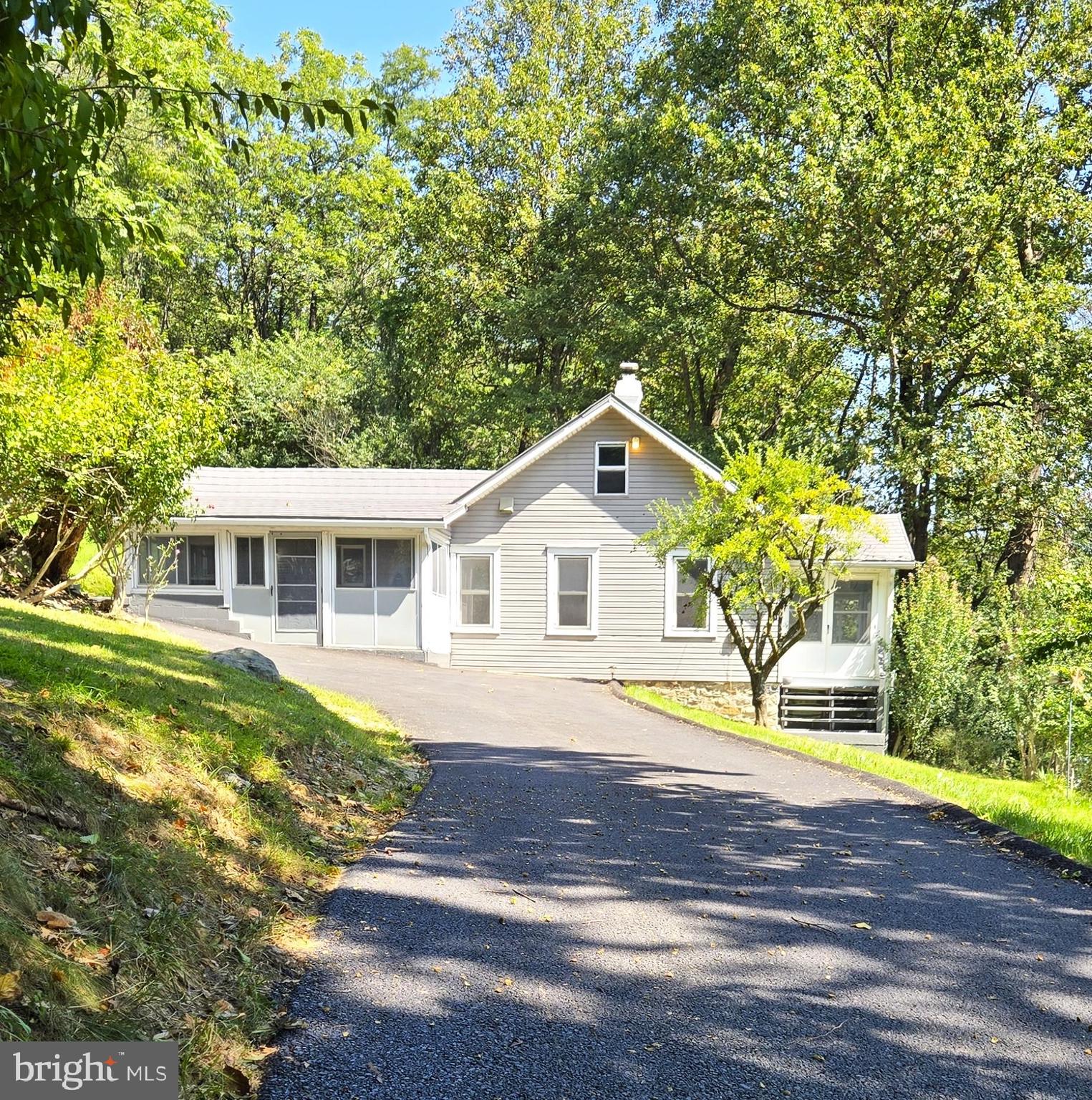 a front view of a house with a garden and yard