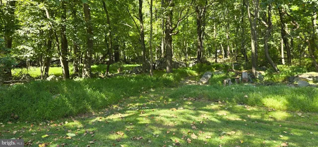a view of a house with swimming pool and sitting area