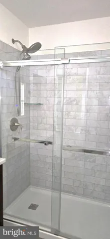 a bathroom with a shower and a glass door shower