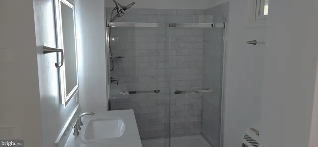 a view of a house with a small yard and large tree