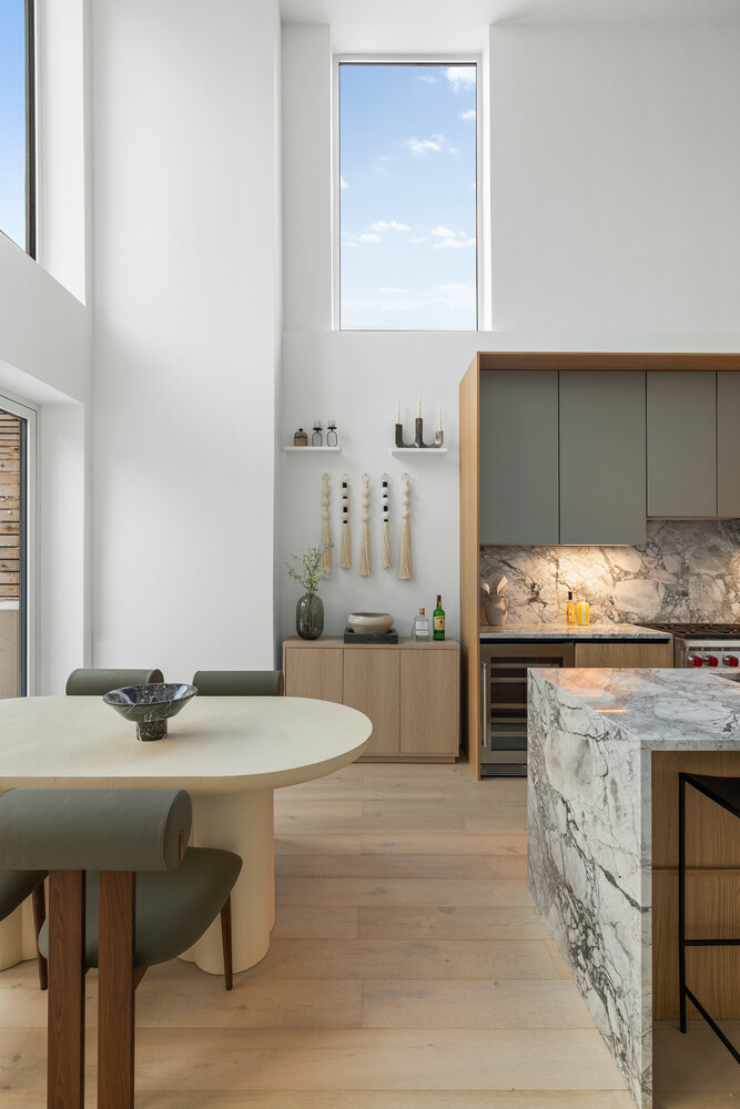 79 South 2nd Street, Unit THA Brooklyn, NY 11249 - Photo 2 of 28 a kitchen with granite countertop a table chairs sink and cabinets