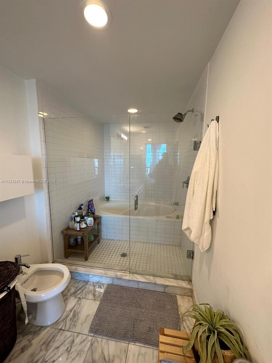 888 Biscayne Boulevard, Unit 3611 Miami, FL 33132 - Photo 6 of 13 a bathroom with a sink a toilet and a shower