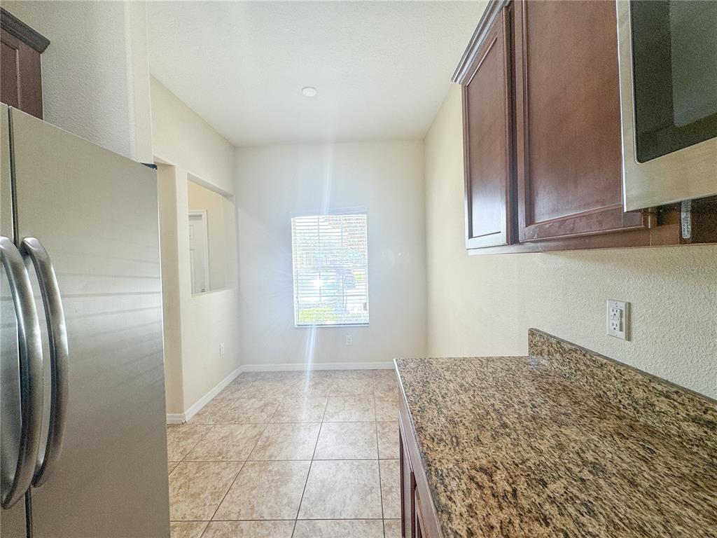 8542 Gablebend Way, Unit 8542 Tampa, FL 33647 - Photo 5 of 14 a kitchen with granite countertop a refrigerator and cabinets