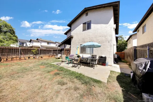 a view of a house with sitting area and furniture in patio