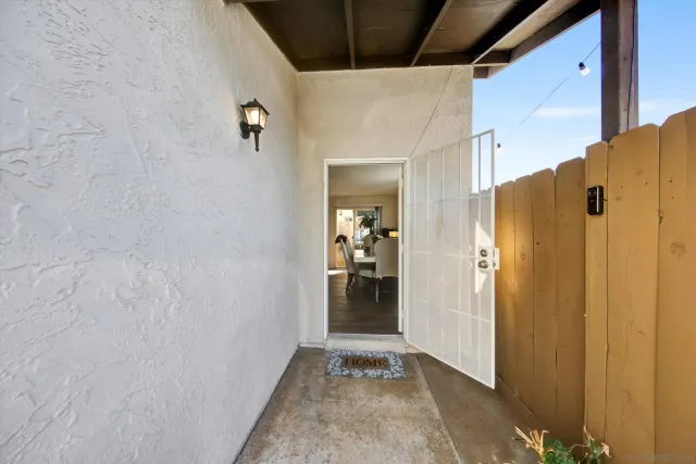 a room with furniture a rug kitchen view and a window