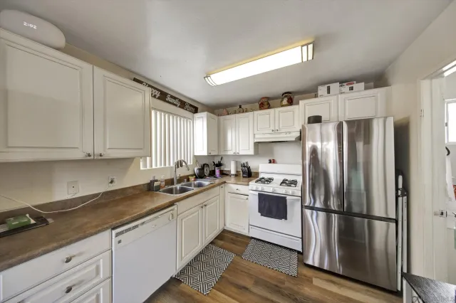 a view of a livingroom with furniture flat screen tv and staircase