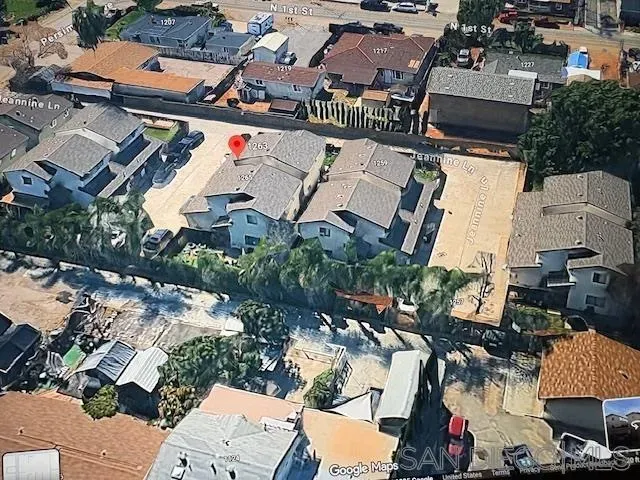 an aerial view of a houses with yard
