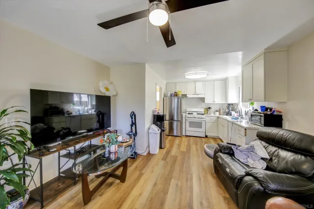 a kitchen with stainless steel appliances lots of wooden furniture and wooden floor
