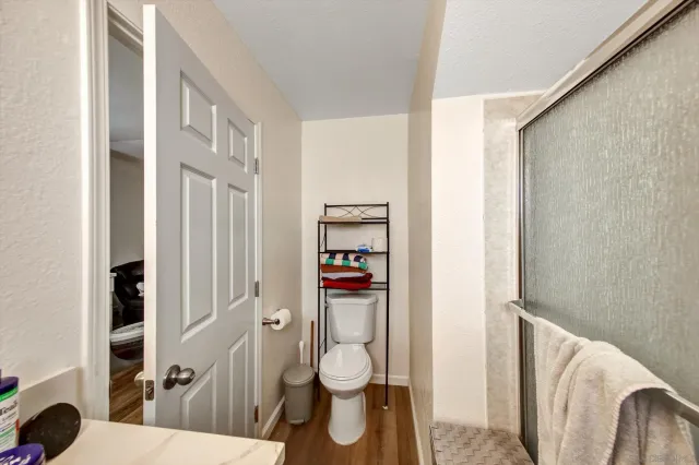 a bathroom with a toilet and a shower