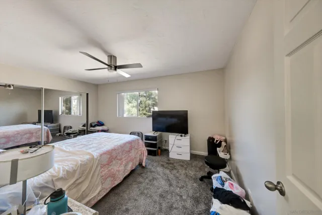 a spacious bedroom with a bed and a large window