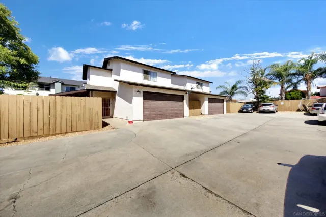 a view of a parking space in front of a house
