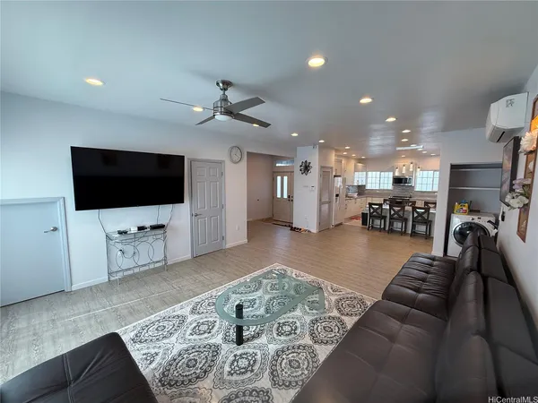 a living room with furniture and a flat screen tv
